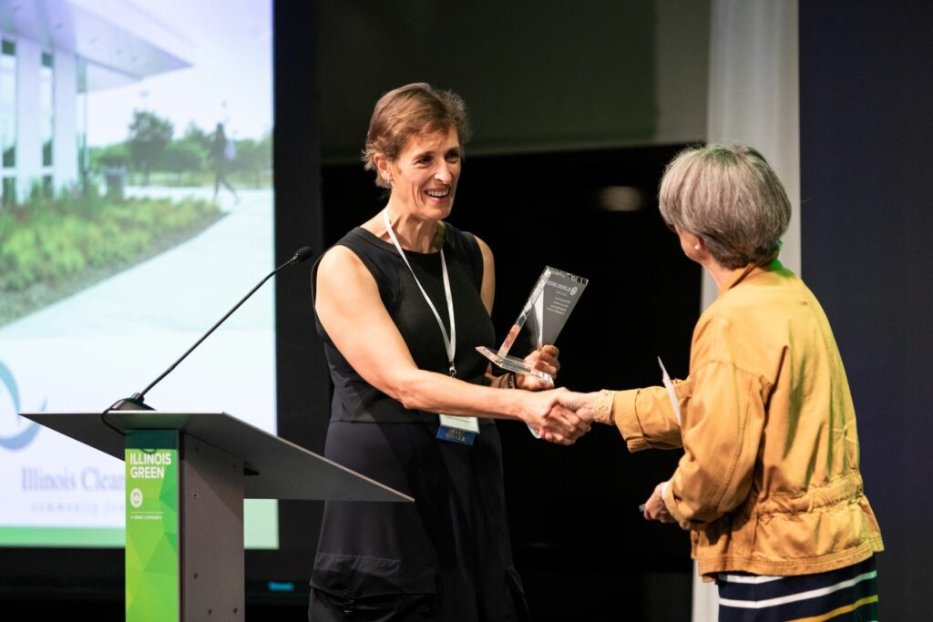 Gabriela Martin accepts the Emerald Award on behalf of the Illinois Clean Energy Community Foundation.