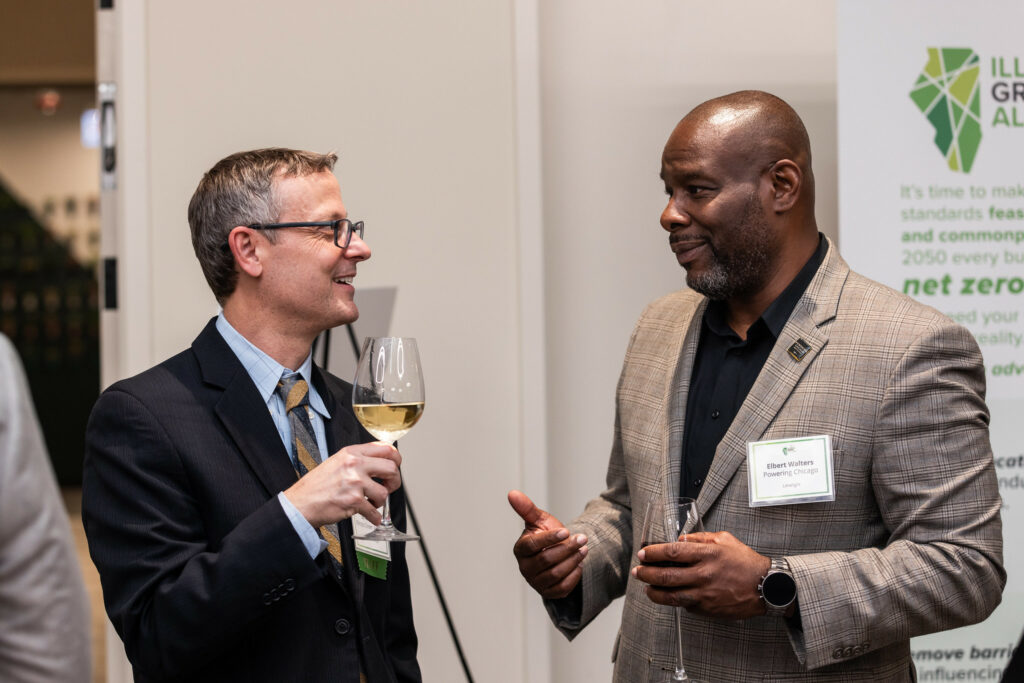 Executive Director Brian Imus chats with Powering Chicago Director Elbert Walters.