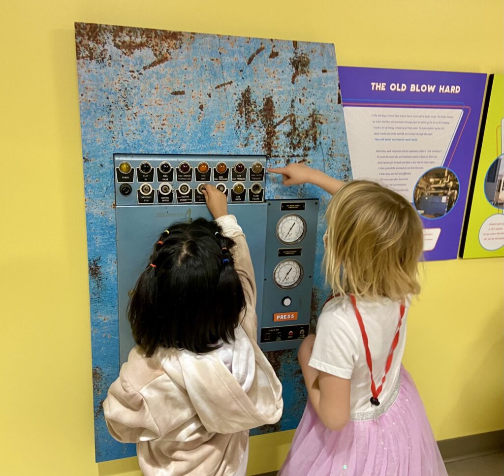 Prairie Trails kindergarten students interact with one of the school's displays to learn about the buildings new HVAC.