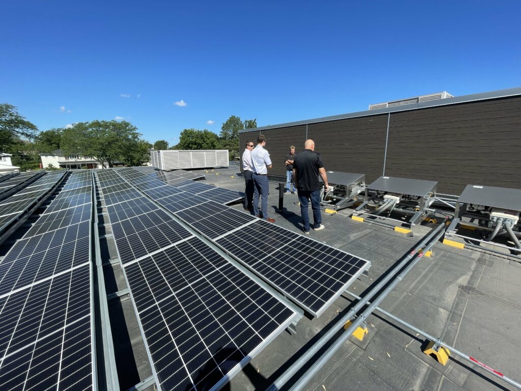 District administrators and architects inspect the Prairie Trails solar panels.