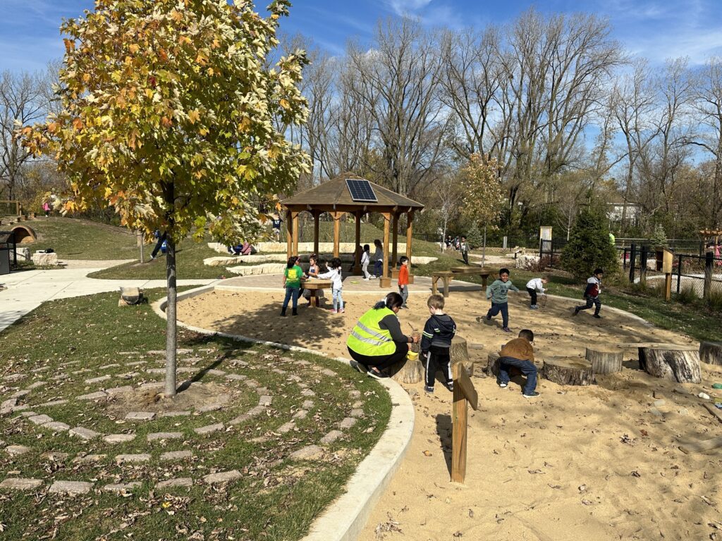 Students enjoy playing in the natural playground area.