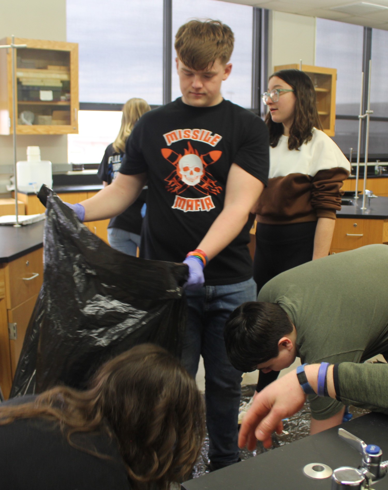 Milledgeville High School students sort through their school's trash to determine what can be recycled. 